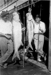 EH8128P 1928 Ernest Hemingway and John Dos Passos pose with two tarpon fish, Key West, 1928. Photograph in the Ernest Hemingway Collection of the John F. Kennedy Presidential Library and Museum, Boston.